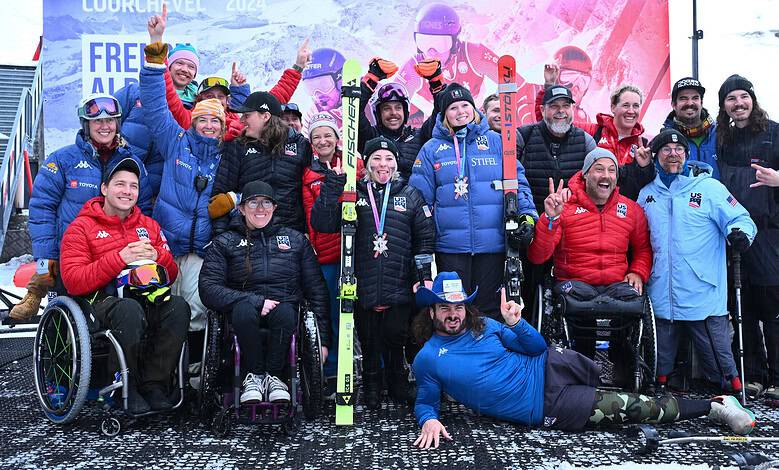 Celebrating winter sports and adaptive skiing with a diverse group of para-athletes and supporters at a winter competition, showcasing resilience and the joy of winter sports.