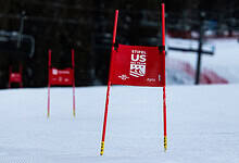 Ski racing gate on a snowy slope at a winter sports competition.
