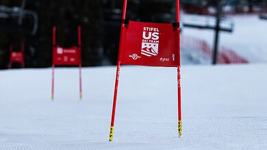 Ski racing gate on a snowy slope at a winter sports competition.