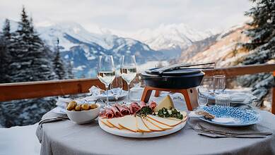 Elegant winter mountain outdoor dining setup with cheese, cold cuts, and wine in snowy Alps, perfect for winter holiday meals.