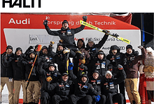 Audi FIS Ski World Cup team celebrating victory on podium with skis and winter sports gear.