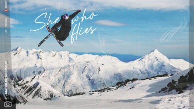 Snowboarder performing aerial jump on mountain snow peak in winter landscape, highlighting winter sports and adventure.