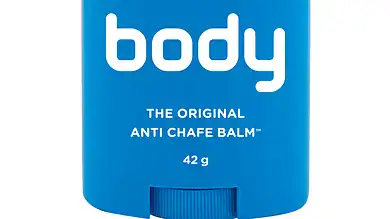 Silicone anti-chafe balm in blue container, body glide brand, designed for smooth skin protection during winter activities or sports. Compact, portable, perfect for winter skin care.