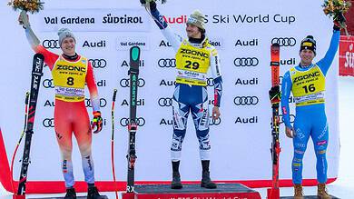 1. Alpine ski racers on podium celebrating at FIS Ski World Cup in Val Gardena, showcasing winter sports excellence and ski competition medals.