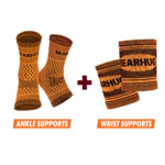 Pair of orange Bearhug ankle supports and two orange wrist supports with black text, set against a black background.