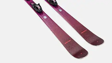 Pair of pink skis with black bindings designed for winter skiing activities.