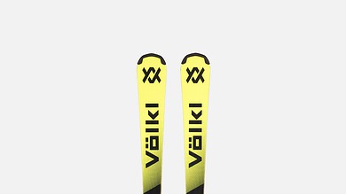 Pair of Völkl Junior Pro skis in yellow and black with bindings, designed for winter skiing enthusiasts.